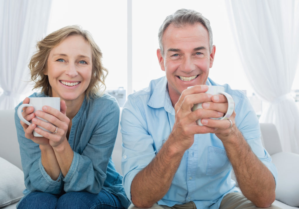 couple smiling and drinking coffee